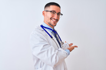 Young doctor man wearing stethoscope over isolated background Inviting to enter smiling natural with open hand