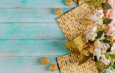Matzah bread with kiddush and flowers. Jewish Passover holiday concept.