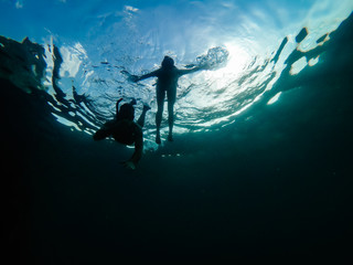 Obraz na płótnie Canvas Underwater photo of couple snorkeling in a sea