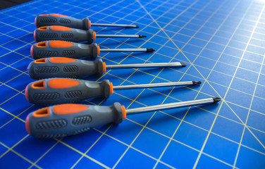 Row of Screwdrivers on Blue Stationary Mat