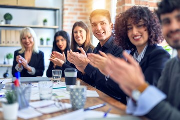 Group of business workers smiling happy and confident. Working together with smile on face looking at the camera applauding at the office