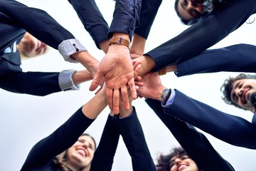 Group of business workers standing with hands together at the office