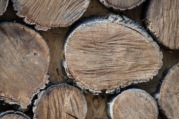 Wall of stacked wood logs as background