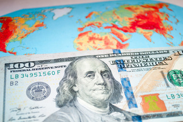Money on the world map. We are planning a trip. Vacation expenses. Which country to invest in.