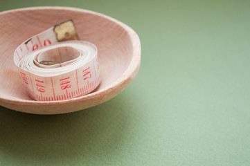 Measuring tape on a spoon. Healthy lifestyle. Lose weight by the summer. Proper nutrition. Diet.	