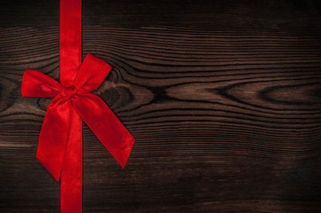 Wooden brown background with colored bow