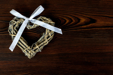 Heart decoration with a bow on a wooden background
