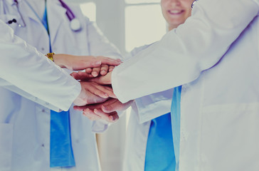 Doctors and nurses in a medical team stacking hands