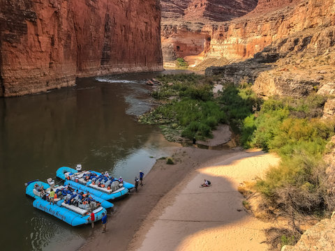 Colordo River trip stopped at beach of South Canyon.  Two blue rafts on the river's edge with ropes in the sand.  Redwall Limestone of Marble Canyon in the Grand Canyon National Park, Arizona