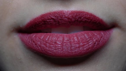 extreme close-up woman's lips blowing a kiss and smiling - Powered by Adobe