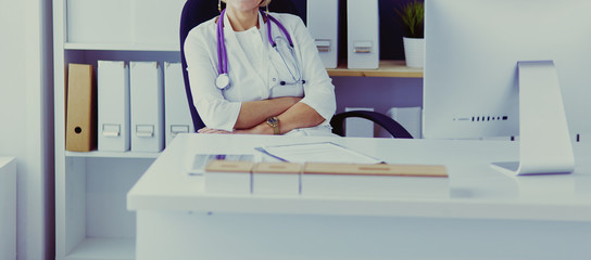 Serious medical team using a laptop in a bright office