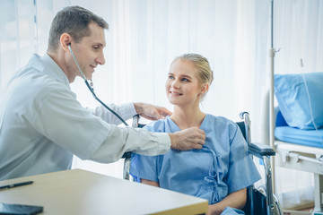 Fototapeta premium The doctor examined the patient's pulse,Doctor checking young woman's pulse in hospital,Coronavirus Disease 2019 (COVID-19).
