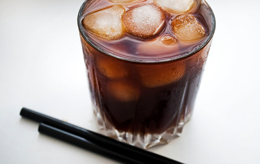 Summer cocktail. Cola with ice. A glass of refreshing cold drink. Whiskey.