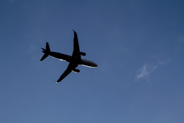 Plane in blue cloudy sky