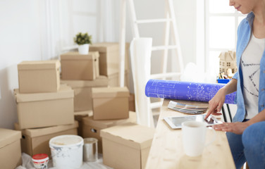 A beautiful single young woman unpacking boxes and moving into a new home