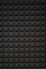 Foam material specifically for the walls of a recording studio. Soundproof and sound absorbing materials. Details, close-up of triangles wall decoration. Soft focus and shallow depth of field.