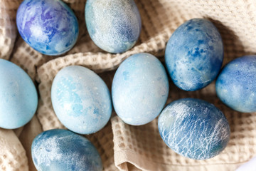 Easter atmosphere. Dyed Easter eggs and spring flowers on a white background. Easter atmosphere.
