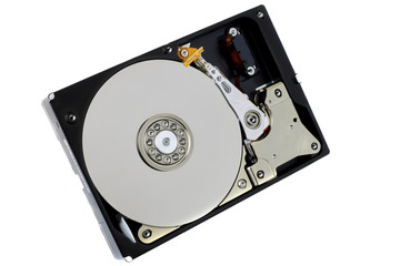 Hard disk drive isolated on white background. A computer's HDD data storage without protective cover, show the magnetic disk and electronic components inside the device.