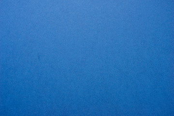 Classic blue background - abstract color trend year background. Texture and texture - paper deep blue color. Top view and soft focus.