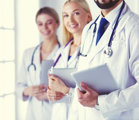 Fototapeta premium A medical team of doctors, man and women, isolated on white background