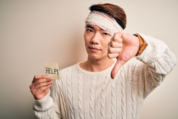 Young handsome chinese man injured for accident wearing bandage on head asking for help with angry...