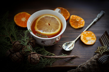 cup of tea with lemon on wooden background