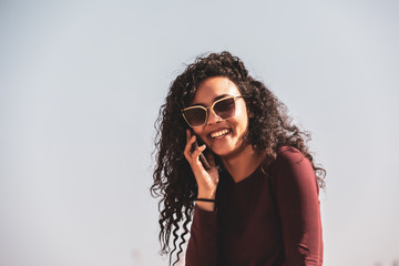 Young And Fashionable Girl Talking With Her Smartphone