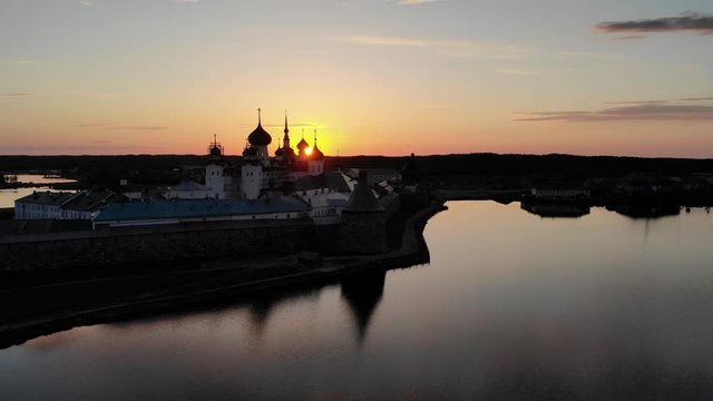 Smooth cinematic flight over the Solovetsky monastery during a beautiful sunset. Solovetsky monastery is an old Russian Orthodox Church monastery, located on the White sea's Islands