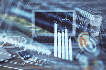 Computer on desktop in office with technology theme hologram. Multi exposure. Tech concept.