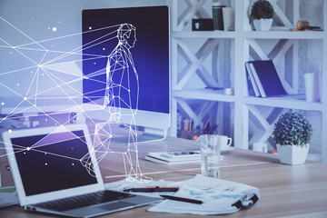 Desktop computer background in office and start up theme hologram drawing. Double exposure. Startup concept.