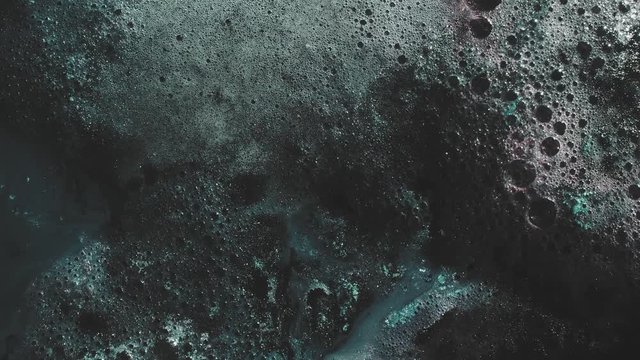 Ink water. Supernatural force. Glitter teal blue bubbling fluid overlay.