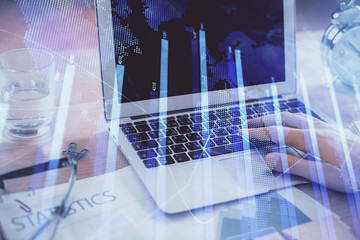 Multi exposure of market chart with man working on computer on background. Concept of financial...