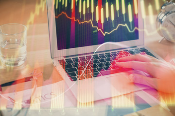 Multi exposure of market chart with man working on computer on background. Concept of financial...