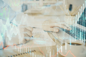 Multi exposure of stock market graph with man working on laptop on background. Concept of financial analysis.