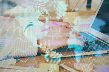 Multi exposure of stock market graph with man working on laptop on background. Concept of financial analysis.