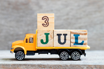 Truck hold letter block in word 3jul on wood background (Concept for date 3 month July)