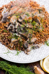 Stewed turkey stomachs with vegetables and buckwheat in a bowl