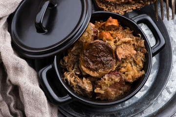 Traditional polish sauerkraut (bigos) with mushrooms and plums for christmas