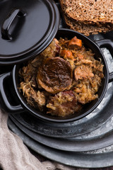 Traditional polish sauerkraut (bigos) with mushrooms and plums for christmas