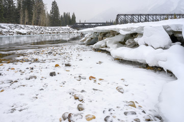 Snowy day at Engine Bridge pedestrian crossing over the Bow River in Canmore, Alberta, Canada