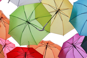 Green, red and blue parasols on a white background. Umbrella many colors.