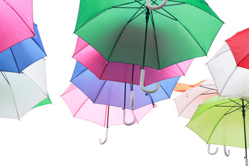 Green, red and blue parasols on a white background. Umbrella many colors.