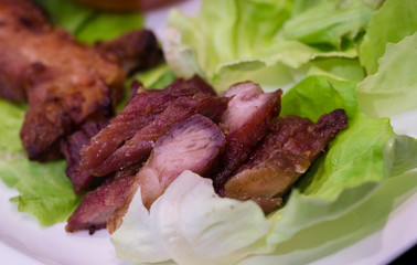 Thai roasted crispy pork on lettuce with Thai Spicy Sauce, Close up view