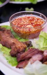Thai roasted crispy pork on lettuce with Thai Spicy Sauce, Close up view