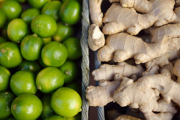 Fresh healthy bio citrus in Monaco supermarket - limes and ginger roots. Background.