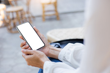 Mockup image blank white screen cell phone.woman hand holding texting using mobile on desk at coffee shop.background empty space for advertise text.people contact marketing business,technology