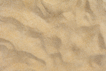 Closeup shot of sand texture on the beach as background