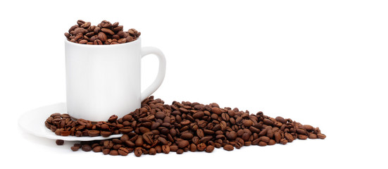 white coffee cup with saucer overfilled with roasted coffee beans isolated on white background with copy space, suitable for header or banner