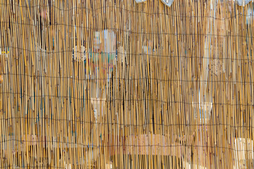 Bamboo divider screen in bright sunlight at an outdoor market