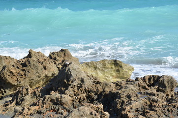 Fototapeta na wymiar sand and rocks and ocean water at beach